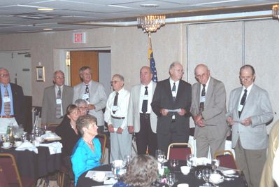 2006 Reunion 75th Anniversary Program Initiation Rite Photo 1
In the three photos a re-initiation ceremony was conducted by Jim Sweet, `56, President, pictured separately.  Most of the nine past presidents in attendance participated in the ceremony, assisted by other members.
 
From the far left of photo 1:  Hal Johnson, `51; Fred Culbert, `65, Past President, 1964-1965, 2nd Sem.; John Schneider, `65, Past President, 1964-1965, 1st Sem.; Norm Arnold, `40; Jim Finnen, `54, Past President, 1953-1954; Howard Lynch, `43, Past President, 1942-1943; Richmond Young, `44; Ken Doran, `39; (just out of view to his left is Ken Haser, `40);
