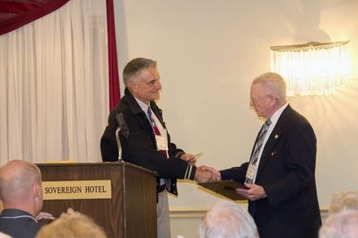 Saturday Banquet
Emcee Gerry Leggieri, 68, presents Jack Higham with a monetary gift of $150 from the Potter Club Alumni Association in appreciation for his service.

